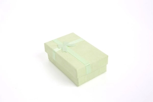 Detail view of a rectangular mint green jewelry gift box with a matching ribbon bow
