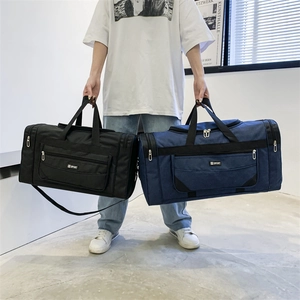 Detail of waterproof nylon travel bags in black and blue with reinforced handles