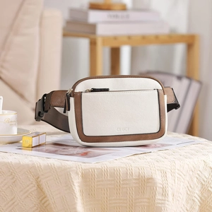 Detail of white and brown faux leather fanny pack with contrast trim and CLUCI logo