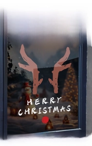 Detailed view of reindeer antlers and Merry Christmas lettering on window glass stickers