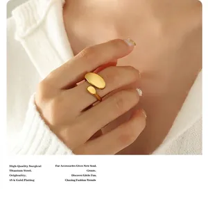 Detail of minimalist 18k gold plated surgical titanium steel double oval open ring
