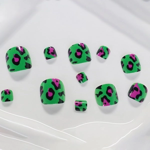 Short square press-on toenails featuring green base with pink and black leopard patterns