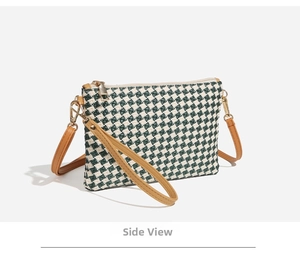 Side view of houndstooth crossbody bag with green fabric and brown leather straps