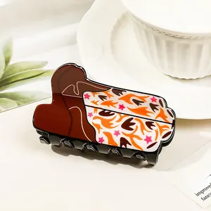 Detailed close-up of acrylic hair claw clip featuring abstract bohemian floral patterns