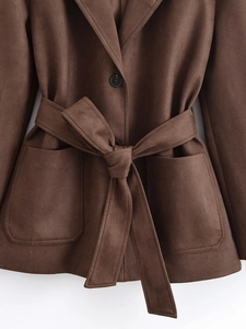 Detail of suede trench coat waist belt and large patch pockets in dark brown finish