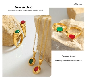 Macro detail of Thai vintage jewelry set with oval green and red gemstones in gold finish