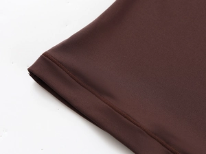 Close-up of double stitching and knit texture on dark brown slim fit athletic t-shirt