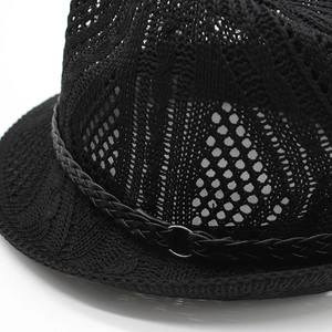 Close-up of black breathable knit jazz hat featuring hollow mesh texture and buckled band