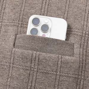 Detail view of the deep pocket on a coffee-colored knit vest with a smartphone inside