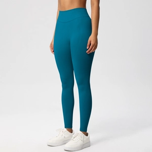 Close-up of high-waisted seamless yoga pants with peach lift effect in dark teal
