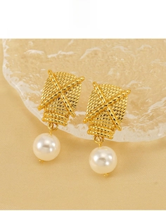 Detailed close-up of gold titanium steel earrings with woven texture and white pearl drop