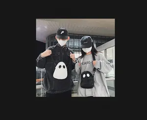 Street style view of ghost-shaped crossbody bags in black and white worn by models