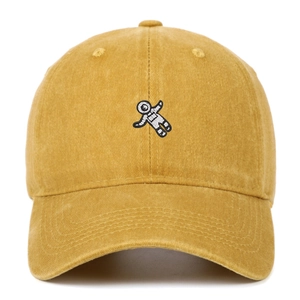 Close-up of mustard yellow washed cotton baseball cap with astronaut embroidery