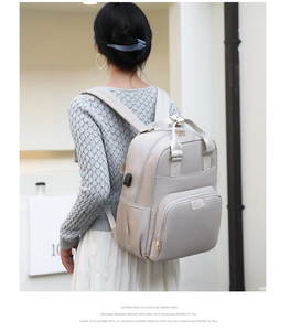 Close-up of functional USB charging port on large capacity diaper backpack for moms
