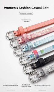 Close-up of glitter cowhide leather belts with silver horseshoe buckles in multi-colors