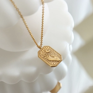 Golden titanium steel necklace with square pendant featuring hand and crescent moon relief