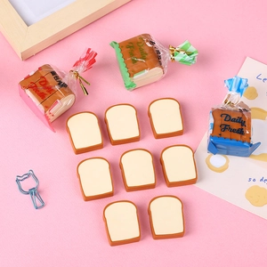 Creative toast bread erasers in bag and slice shapes on a soft pink background