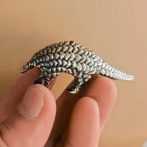 Miniature vintage bronze pangolin figurine with detailed scale textures for desk decor