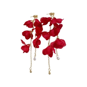 Elegant red flower tassel earrings with gold chains and pearls on a white background