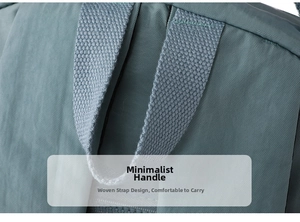 Close-up of thickened nylon webbing handle on a lightweight blue-grey backpack