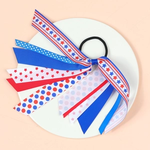Girl's hair scrunchie with American flag patterns of stars and stripes on a white plate