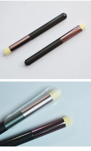 Close-up of silicone lip brushes with rose gold and silver ferrules and clear protective caps