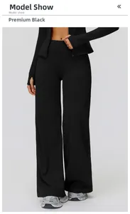 Detail of high-waisted black wide-leg sports pants and zip-up jacket in premium black