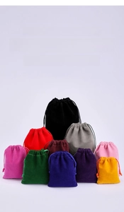 Detail showing various colors of velvet drawstring jewelry pouches in a stacked arrangement