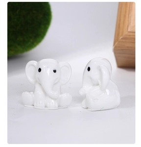Front and side view of two cute white resin elephant figurines for desk decoration
