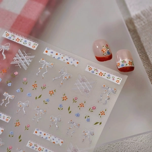 Floral nail art stickers with gold foil, featuring small flowers and lace on nails