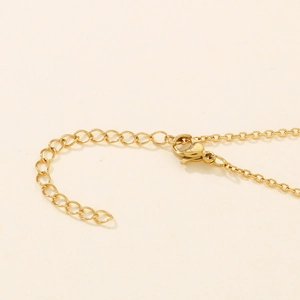 Detailed close-up of golden necklace adjustable chain and lobster clasp closure