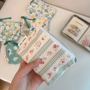 Detailed macro view of various floral cotton pouches with a simple wish woven label