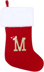 Detail of red Christmas stocking featuring white plush cuff and a gold letter M embroidery