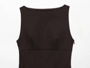 Detail of a black sleeveless dress showing the boat neck design and side zipper closure