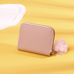 Pink PU leather short wallet featuring a soft pompom charm and golden zipper detail