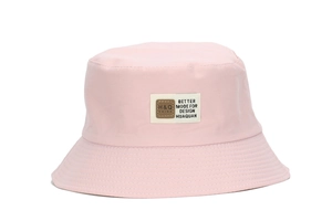 Detail of pink cotton sun bucket hat featuring a rectangular logo patch and stitched brim