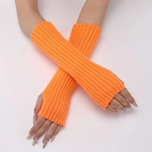 Detail of bright orange ribbed knit arm warmers with thumb holes for autumn winter style