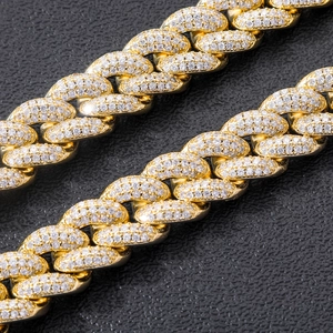 Macro shot of 20mm gold Cuban link bracelet featuring detailed micro-pave zircon stones
