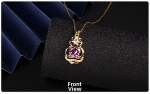 Detail of golden gourd pendant featuring a purple round zircon and small pavé crystals