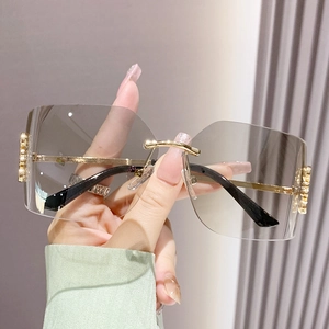 Fashionable rimless square sunglasses with gradient gray lenses and gold metal frames