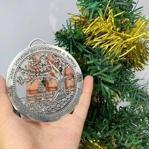 Close-up of tree of life memorial ornament with engraved sentimental quote in antique silver