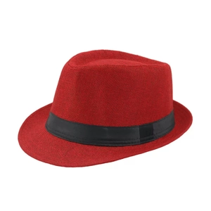 Detailed texture of red woven fedora hat with a black decorative band and wide brim