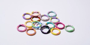 Close-up of colorful polka dot spring rings for DIY keychains and craft accessories