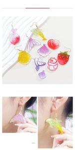 DIY silicone mold resin charms featuring shells dolphins and strawberries in pastel glitters