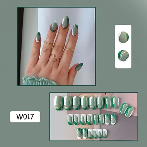 Detail view of green and white wave pattern press-on nails with gold accents W017