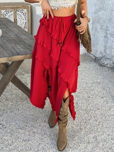Detail of red vacation skirt with ruffled hemline, drawstring waist and side slit detail