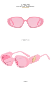 Detail view of pink oval sunglasses featuring elegant golden leaf metal decor on temples