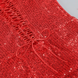 Close-up of red sequined fabric with crisscross tie-up bow detail on evening dress