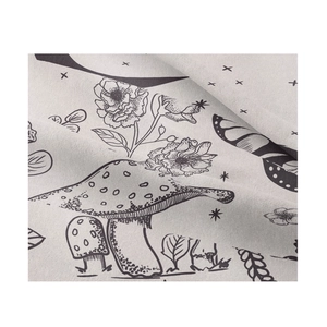 Close-up of tapestry fabric showing black line art mushrooms, flowers and butterflies
