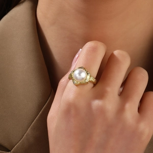 Close-up of vintage 18k gold plated ring with white pearl and sparkling zircon accents
